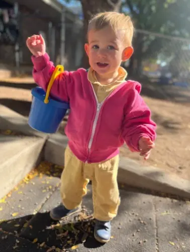 Kid With Bucket Hanging in Hand