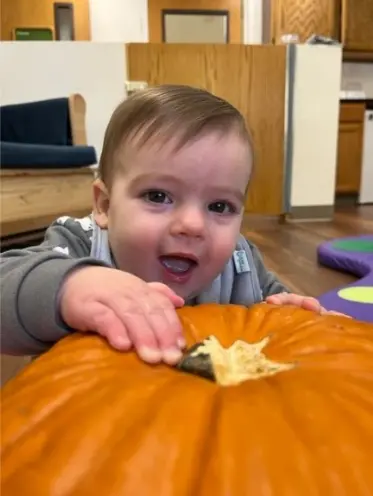 Boy Playing with Pumpkin